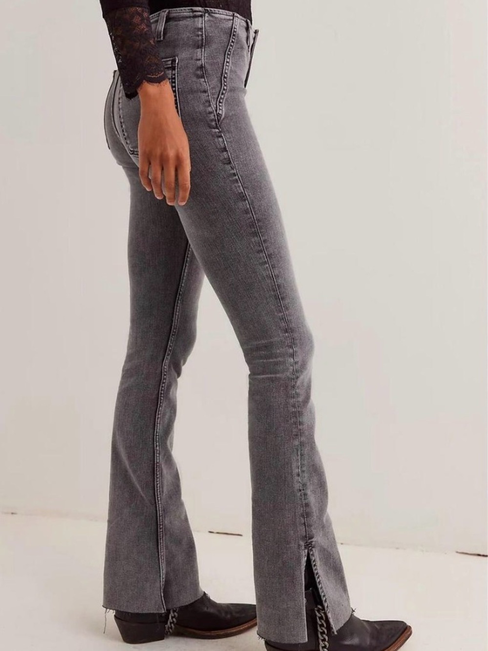 “We The Free" Level Up Slit Slim Flare Jeans with grey wash and frayed hem.